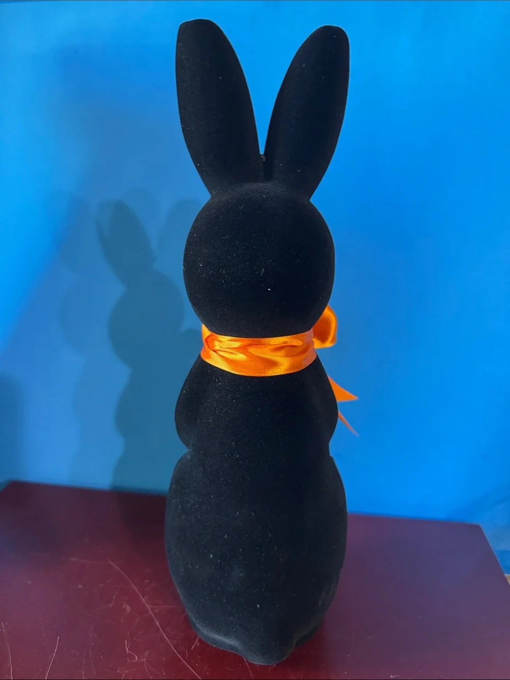 Black flocked (fuzzy) bunny figurine w/orange bow contemporary Easter- NEW